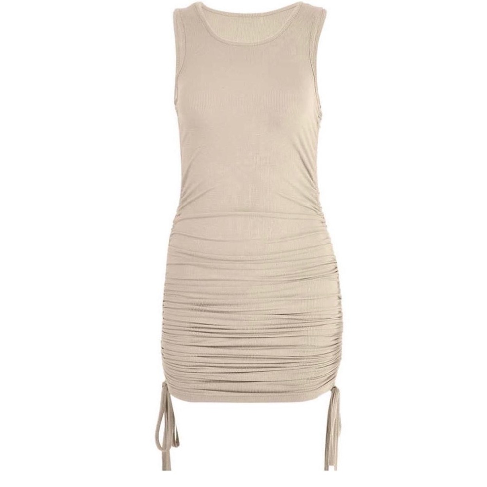 A Nude/ Cream Color bodycon dress with drawstrings on side to adjust length.